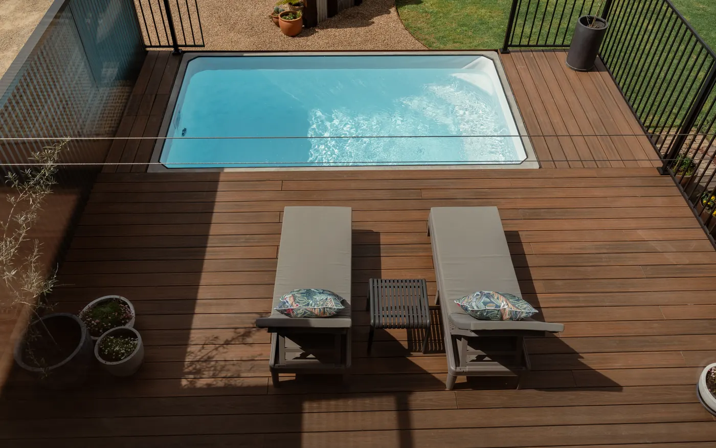 The plunge pool and two loungers on the timber deck
