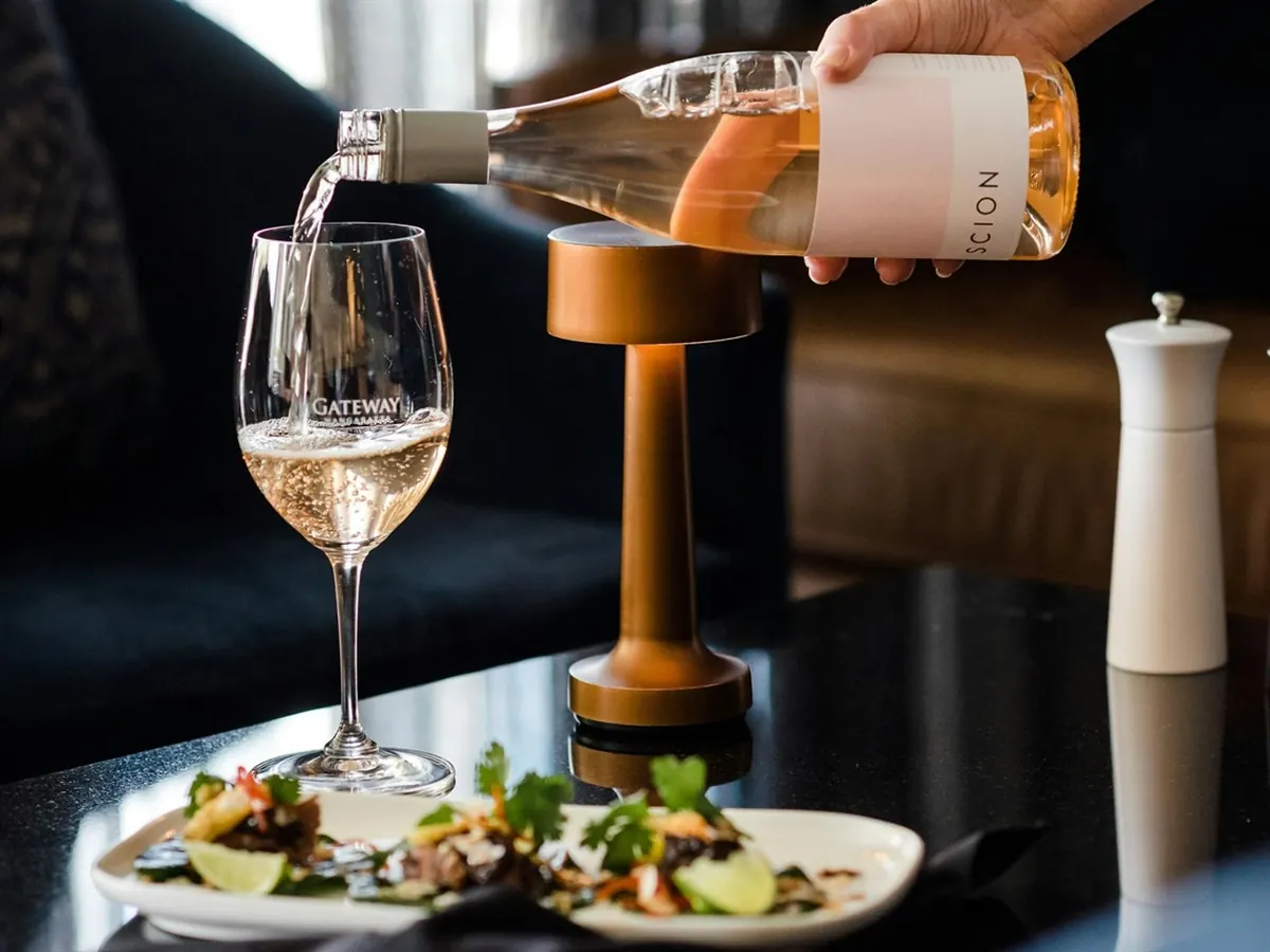 Wine being poured over a plated dish at a Wangaratta restaurant