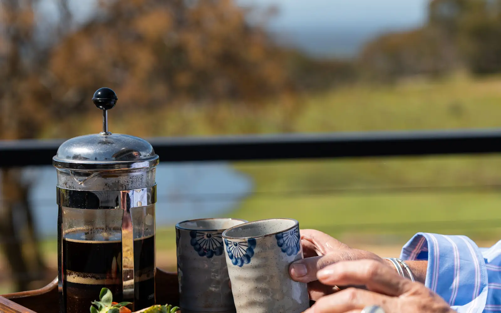 The balcony table set for breakfast, with the outlook beyond