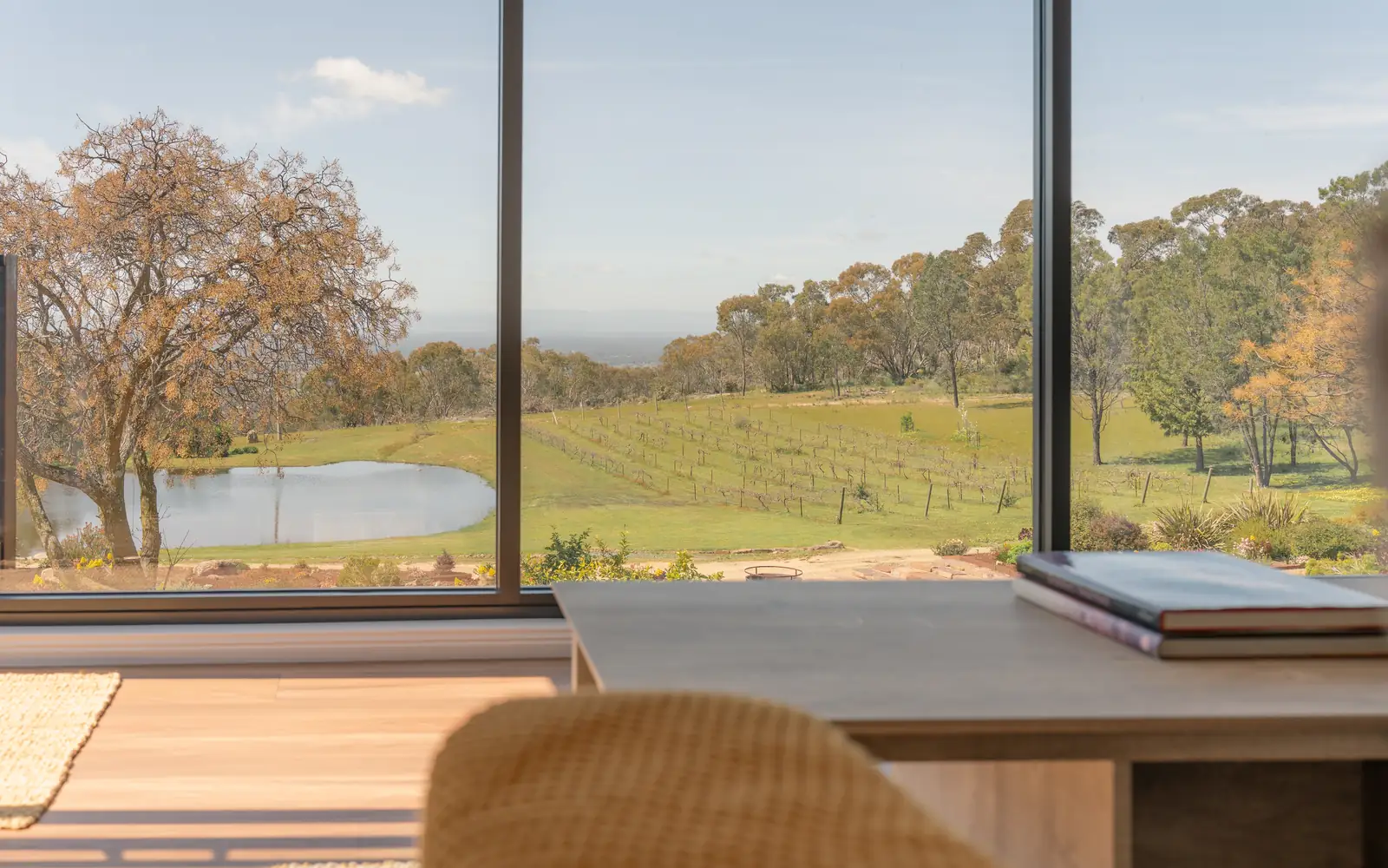 The window wall of the upstairs living area looking out over the paddocks