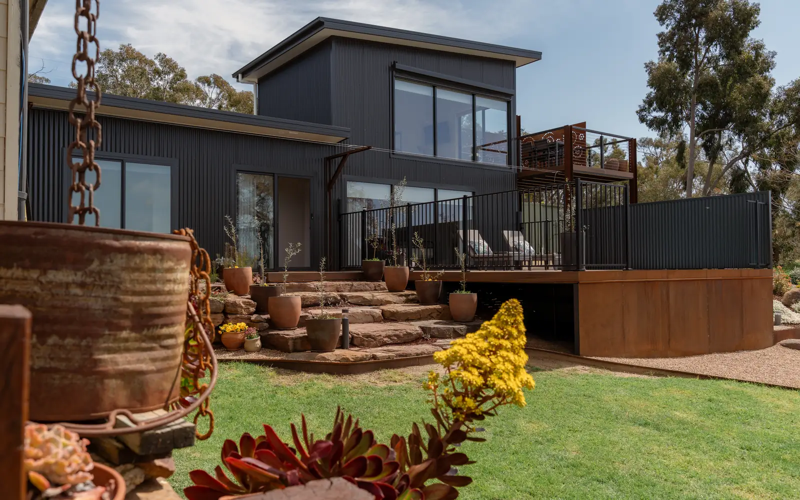 The accommodation on its lawn, with the bushland around it